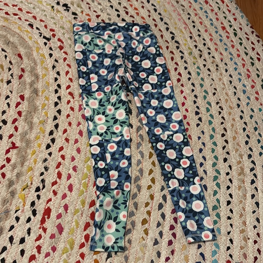 Patched pants with a floral design that pops and is athletic and is made for 7-8